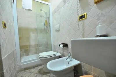 a bathroom with a toilet and a shower and a sink at Casale De Santis in Rome