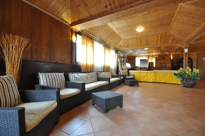 a waiting room with couches and chairs and a counter at Casale De Santis in Rome