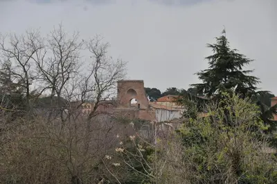an old building on top of a hill with trees at Casale De Santis in Rome
