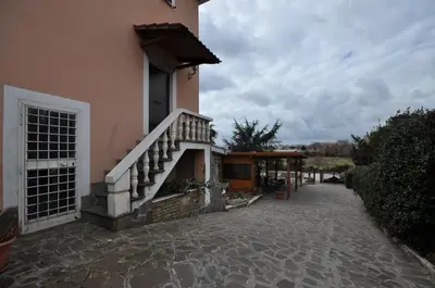 a building with a staircase on the side of it at Casale De Santis in Rome