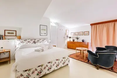 a bedroom with a bed and a chair at Al Portico 39 apartment with terrace in Rome