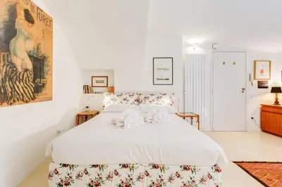 a white bedroom with a large bed with white sheets at Al Portico 39 apartment with terrace in Rome