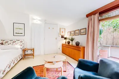 a living room with a bed and a table at Al Portico 39 apartment with terrace in Rome