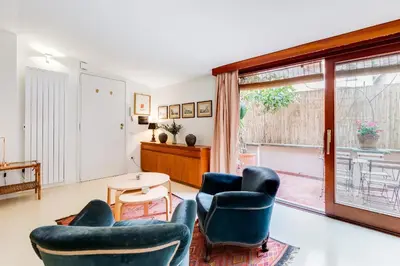 a living room with two chairs and a table and a window at Al Portico 39 apartment with terrace in Rome
