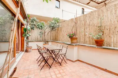 a patio with a table and chairs and a fence at Al Portico 39 apartment with terrace in Rome