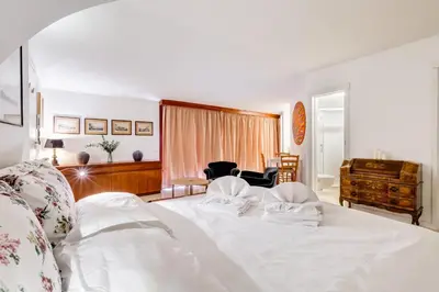 a bedroom with a white bed with two pillows on it at Al Portico 39 apartment with terrace in Rome