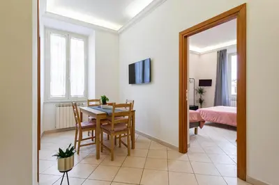 a dining room with a table and a mirror at Redseven Rome Apartments in Rome