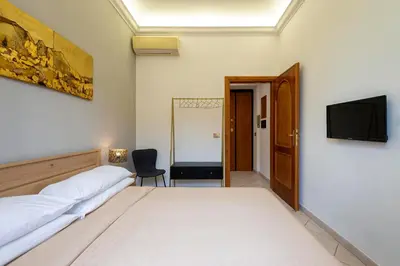 a bedroom with two beds and a flat screen tv at Redseven Rome Apartments in Rome