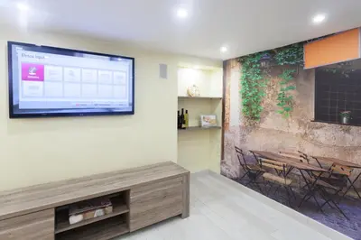 a living room with a flat screen tv on a wall at Trastevere Charming Loft in Rome
