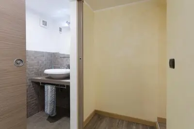 a bathroom with a sink and a mirror and a toilet at Trastevere Charming Loft in Rome