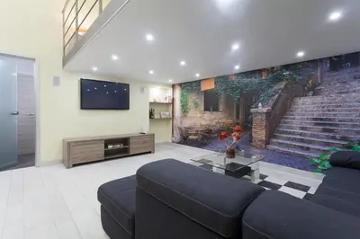 a living room with a couch and a painting on the wall at Trastevere Charming Loft in Rome