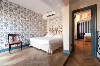 a bedroom with a bed and a desk in a room at Boutique Hotel Anahi in Rome