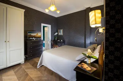a white bedroom with two beds and a window at Boutique Hotel Anahi in Rome