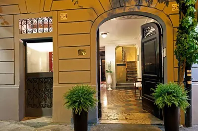 a dining room with a table and red chairs at Boutique Hotel Anahi in Rome