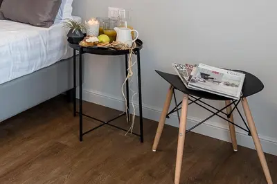 two tables with food on them next to a bed at Z-ArchSuites in Rome