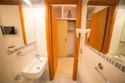 a bathroom with a sink and a mirror at All Seasons in Rome