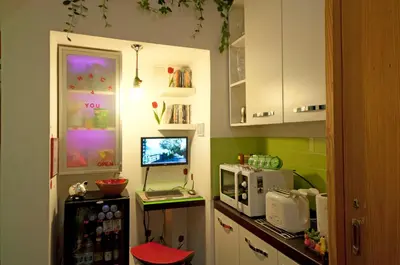 a kitchen with a counter with a computer and a microwave at Rhome86 in Rome