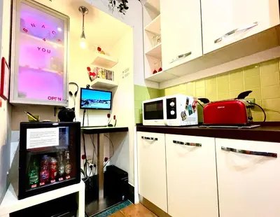 a kitchen with a refrigerator and a microwave at Rhome86 in Rome