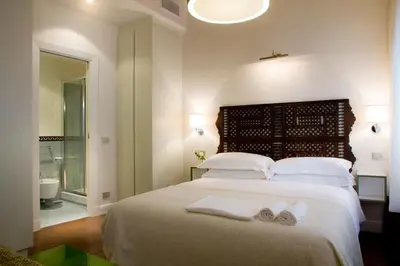 a bedroom with a bed with two towels on it at La Gensola In Trastevere in Rome