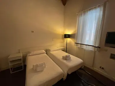 a hotel room with two beds and a window at La Gensola In Trastevere in Rome
