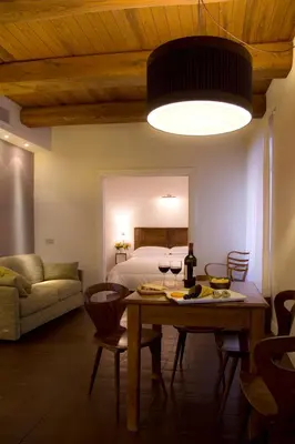 a living room with a table and a bed at La Gensola In Trastevere in Rome