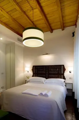 a bedroom with a large bed with two towels on it at La Gensola In Trastevere in Rome