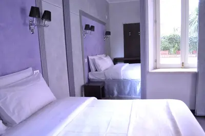 a bedroom with two beds and a window at Tiburtina House in Rome
