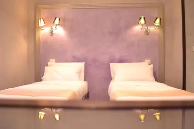 two beds in a room with a mirror at Tiburtina House in Rome
