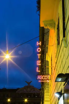 a neon sign on the side of a building at Hotel Ascot in Rome