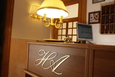 a sign on a desk with a computer on it at Hotel Ascot in Rome