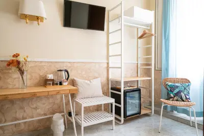 a room with a desk and a bunk bed at Hotel Ascot in Rome
