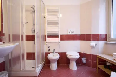 a bathroom with a toilet and a shower and a sink at Hotel Ascot in Rome