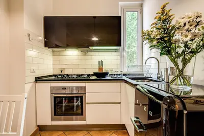a kitchen with a stove top oven next to a window at ilPlatano-Testaccio in Rome