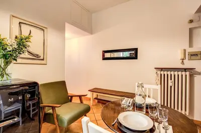 a living room with a table and chairs and a radiator at ilPlatano-Testaccio in Rome