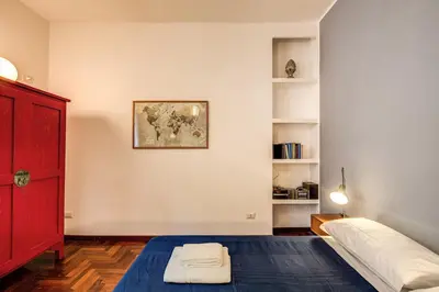 a bedroom with a bed and a red door at ilPlatano-Testaccio in Rome