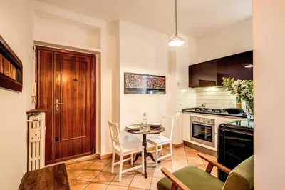 a kitchen with a table and chairs in a room at ilPlatano-Testaccio in Rome