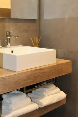 a bathroom with a sink and a pile of towels at Eighty Four Rooms in Rome