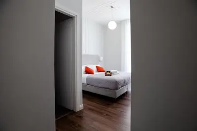 a bedroom with a bed with orange pillows and a window at Eighty Four Rooms in Rome