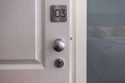 a white door with the number on it at Eighty Four Rooms in Rome