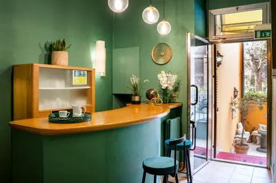 a bar in a room with green walls and stools at Domus Pinciana in Rome