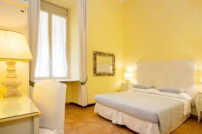 a bedroom with a white bed and a window at Domus Pinciana in Rome