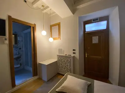 a living room with a door and a window at Condotti Rooms in Rome
