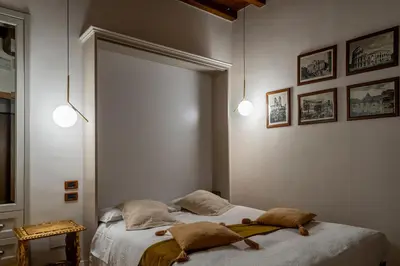 a bedroom with two beds and a mirror at Condotti Rooms in Rome