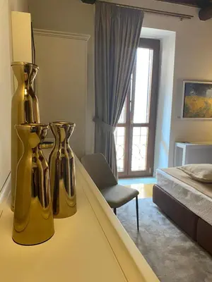 two yellow vases sitting on a table in a bedroom at Condotti Rooms in Rome