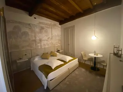 a bedroom with a bed and a table in it at Condotti Rooms in Rome