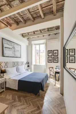 a bedroom with a large bed and a table at The Bluehostel in Rome