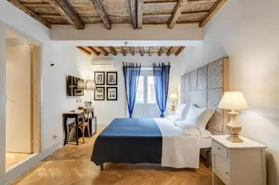 a bedroom with a king sized bed and a desk at The Bluehostel in Rome