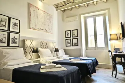 a bedroom with two beds and a window at The Bluehostel in Rome
