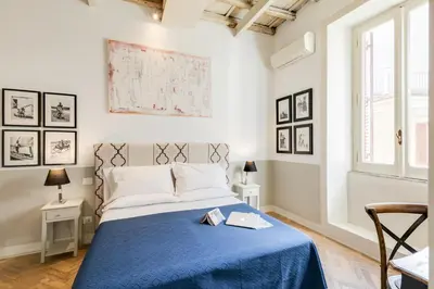 a bedroom with a bed with a blue blanket at The Bluehostel in Rome