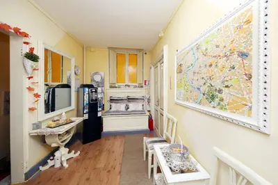 a room with a refrigerator and a table and chairs at Tibullo Guesthouse in Rome